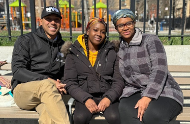 Commissioner Martin, Amoya, and Masada sitting on a bench 